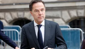 NATO Secretary General Mark Rutte holds two mobile phones as he is pictured outside the Hotel Bayerischer Hof, venue of the 62nd Munich Security Conference (MSC), on February 14, 2026 in Munich, southern Germany. (Photo by Michaela STACHE/AFP)