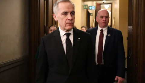 Canada's Prime Minister Mark Carney enters the House of Commons to deliver a statement on the mass shooting in Tumbler Ridge on Parliament Hill on February 11, 2026 in Ottawa, Ontario. Canada was in mourning Wednesday, Prime Minister Mark Carney said, after a lone shooter killed at least nine people, including seven at a school, and injured dozens more in a remote western town. "What happened has left our nation in shock and all of us in mourning," an emotional Carney told parliament. (Photo by Dave Chan/AFP)