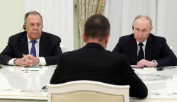 In this pool photograph distributed by the Russian state agency Sputnik, Russia's President Vladimir Putin (R) and Foreign Ministar Sergey Lavrov (L) meet with Hungarian Foreign Minister Peter Szijjarto in Moscow on March 4, 2026. (Photo by Mikhail METZEL/POOL/AFP)