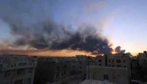 The sun is seen setting through a plume of smoke following a strike on the Iranian capital Tehran, on March 3, 2026. Iran stepped up its attacks on economic targets and US missions across the Middle East on Tuesday as the US president warned it was "too late" for the Islamic republic to seek talks to escape the war. The United States and Israel launched strikes against Iran on February 28, with the killing of Iran's supreme leader and the Islamic republic retaliated with barrages of missiles at Gulf states and Israel. (Photo by ATTA KENARE/AFP)