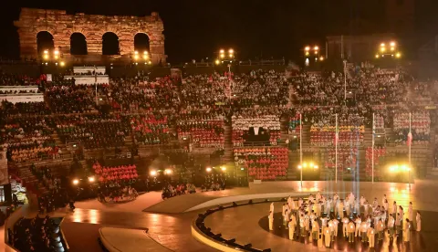 Musicians, choir members and athletes perform during the flag handover ceremony at the closing ceremony of the Milano Cortina 2026 Winter Olympic Games at the Verona Arena in Verona, northern Italy, on February 22, 2026. (Photo by PIERO CRUCIATTI/AFP)