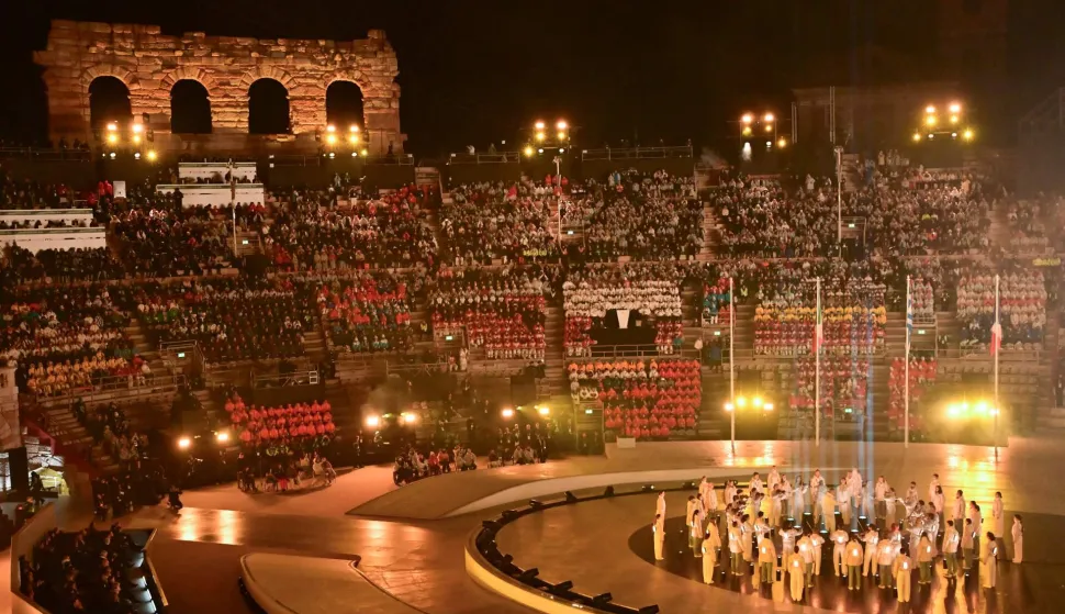 Musicians, choir members and athletes perform during the flag handover ceremony at the closing ceremony of the Milano Cortina 2026 Winter Olympic Games at the Verona Arena in Verona, northern Italy, on February 22, 2026. (Photo by PIERO CRUCIATTI/AFP)