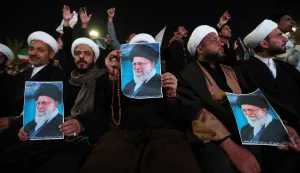 Shiite Muslim clerics hold posters of the late Iranian supreme leader Ayatollah Ali Khamenei, assassinated in a US- Israeli attack on Tehran, as they rally in Tahrir Square, in the Baghdad on March 6, 2026. The United States and Israel launched strikes against Iran on February 28, killing Iran's supreme leader and top military leaders, prompting authorities to retaliate with strikes on Israel and across the Gulf. Fresh strikes rocked Iran and Lebanon on March 6, as Israel and the United States stepped up their attacks in the sprawling Middle East war, with powerful explosions shattering the skies of Tehran. (Photo by Murtaja LATEEF/AFP)