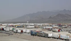 Cargo trucks wait to enter the Pakistan-Iran border crossing at Taftan, Balochistan province on March 2, 2026 amid ongoing US-Israel strikes on Iran. (Photo by Banaras KHAN/AFP)