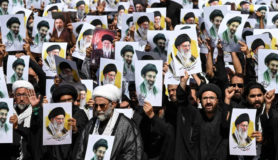TOPSHOT - Shia Muslims holding portraits of Iran?s slain supreme leader Ali Khamenei and of his son, the country's new supreme leader Mojtaba Khamenei, shout anti-US-Israel slogans during the Youm-e-Ali procession in Karachi on March 11, 2026 marking the death anniversary of Imam Ali, son-in-law of Prophet Muhammad. (Photo by Rizwan TABASSUM/AFP)