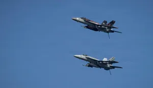 This US Navy handout photo released by US Central Command public affairs on March 12, 2026, shows two F/A-18E Super Hornets, attached to Strike Fighter Squadron (VFA) 14, as they fly over Nimitz-class aircraft carrier USS Abraham Lincoln (CVN 72) in support of Operation Epic Fury, on March 7, 2026. The United States and Israel launched a wave of strikes against targets in Iran on February 28, sparking swift retaliation by the Islamic republic which responded with missile attacks across the region. (Photo by US NAVY/AFP)/RESTRICTED TO EDITORIAL USE - MANDATORY CREDIT "AFP PHOTO/US NAVY and US CENTRAL COMMAND/HANDOUT" - HANDOUT - NO MARKETING NO ADVERTISING CAMPAIGNS - DISTRIBUTED AS A SERVICE TO CLIENTS
