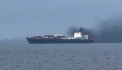 This frame grab from handout UGC video footage by seafarer Wang Shang taken on March 12, 2026 and released to AFPTV on March 13 shows smoke emerging from the Source Blessing cargo vessel, as filmed from the vessel Wang was onboard in the Gulf, north of Dubai. Wang Shang, a seafarer on an LPG vessel in the Gulf, just north of Dubai, talked to AFP on March 13 morning about his experience being stuck on a ship, unable to pass through the Strait of Hormuz. (Photo by Handout/various sources/AFP)/RESTRICTED TO EDITORIAL USE - MANDATORY CREDIT "AFP PHOTO /WANG SHANG/UGC via AFPTV/HANDOUT - NO MARKETING NO ADVERTISING CAMPAIGNS - DISTRIBUTED AS A SERVICE TO CLIENTSATTENTION EDITORS: AFP IS COVERING THE WAR IN THE MIDDLE EAST THROUGH ITS EXTENSIVE REGIONAL NETWORK, INCLUDING ITS BUREAUS IN TEHRAN, BEIRUT, JERUSALEM, THE GULF MONARCHIES, IRAQ, JORDAN, SYRIA AND EGYPT. HOWEVER, SINCE THE START OF THE WAR, THE AGENCY?S JOURNALISTS HAVE BEEN WORKING UNDER INCREASINGLY RESTRICTIVE CONDITIONS. GOVERNMENTS THROUGHOUT THE REGION HAVE IMPOSED LIMITS ON JOURNALISTS? MOVEMENTS, INCLUDING THEIR ABILITY TO PROVIDE VIDEO LIVE STREAMS OF WHAT ARE REGARDED AS SENSITIVE LOCATIONS. SEVERAL GOVERNMENTS AND ARMED GROUPS HAVE BANNED PHOTO AND VIDEO COVERAGE OF MISSILE AND DRONE STRIKES ON WHAT ARE SEEN AS SECURITY-RELATED SITES, THE INTERCEPTION OF INCOMING MISSILES AND DRONES, AND THE REPORTING OF WHAT COULD BE CONSTRUED AS OPERATIONAL MILITARY DETAILS./