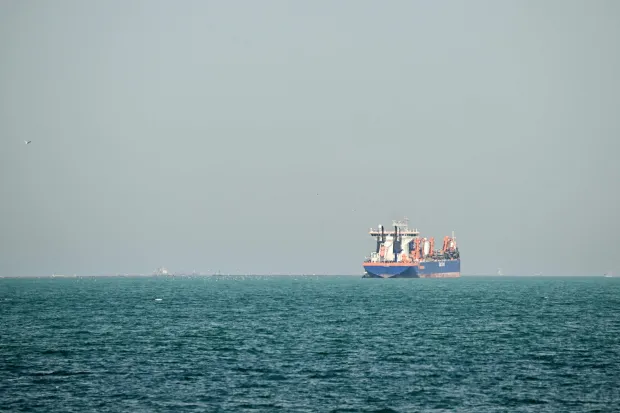 A commercial vessel is pictured offshore in Dubai on March 11, 2026. New attacks hit three commercial ships in the Gulf on March 11, with one of the vessels in flames as Iran pressed its campaign against its oil-exporting neighbours, threatening shipping in the Strait of Hormuz and plunging the global energy economy into crisis. (Photo by AFP)/Attention editors: AFP covers the war in the Middle East through its extensive regional network, including bureaus in Tehran, Jerusalem and several neighboring countries.Since the start of the conflict, journalists have been working under increasingly restrictive conditions. Authorities in several countries have limited reporters? movements, photo and live video coverage from sensitive locations. Some governments and armed groups have banned images of missile or drone strikes and other security-related sites./