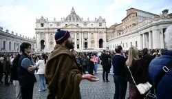 A pilgrim prays during Pope Leo XIV's Sunday Angelus prayer in St. Peter's Square at the Vatican on March 15, 2026. (Photo by Filippo MONTEFORTE/AFP)