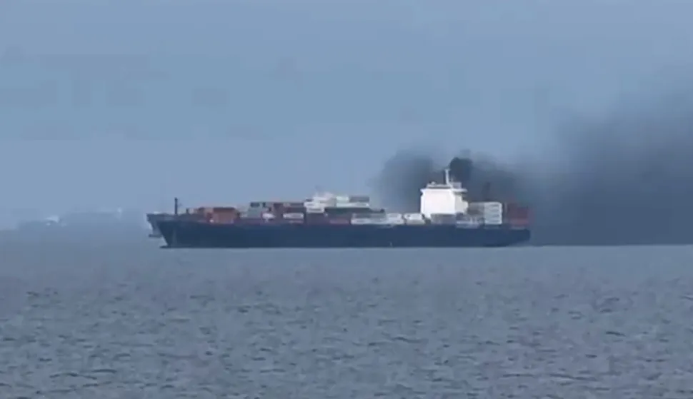 This frame grab from handout UGC video footage by seafarer Wang Shang taken on March 12, 2026 and released to AFPTV on March 13 shows smoke emerging from the Source Blessing cargo vessel, as filmed from the vessel Wang was onboard in the Gulf, north of Dubai. Wang Shang, a seafarer on an LPG vessel in the Gulf, just north of Dubai, talked to AFP on March 13 morning about his experience being stuck on a ship, unable to pass through the Strait of Hormuz. (Photo by Handout/various sources/AFP)/RESTRICTED TO EDITORIAL USE - MANDATORY CREDIT "AFP PHOTO /WANG SHANG/UGC via AFPTV/HANDOUT - NO MARKETING NO ADVERTISING CAMPAIGNS - DISTRIBUTED AS A SERVICE TO CLIENTSATTENTION EDITORS: AFP IS COVERING THE WAR IN THE MIDDLE EAST THROUGH ITS EXTENSIVE REGIONAL NETWORK, INCLUDING ITS BUREAUS IN TEHRAN, BEIRUT, JERUSALEM, THE GULF MONARCHIES, IRAQ, JORDAN, SYRIA AND EGYPT. HOWEVER, SINCE THE START OF THE WAR, THE AGENCY?S JOURNALISTS HAVE BEEN WORKING UNDER INCREASINGLY RESTRICTIVE CONDITIONS. GOVERNMENTS THROUGHOUT THE REGION HAVE IMPOSED LIMITS ON JOURNALISTS? MOVEMENTS, INCLUDING THEIR ABILITY TO PROVIDE VIDEO LIVE STREAMS OF WHAT ARE REGARDED AS SENSITIVE LOCATIONS. SEVERAL GOVERNMENTS AND ARMED GROUPS HAVE BANNED PHOTO AND VIDEO COVERAGE OF MISSILE AND DRONE STRIKES ON WHAT ARE SEEN AS SECURITY-RELATED SITES, THE INTERCEPTION OF INCOMING MISSILES AND DRONES, AND THE REPORTING OF WHAT COULD BE CONSTRUED AS OPERATIONAL MILITARY DETAILS./