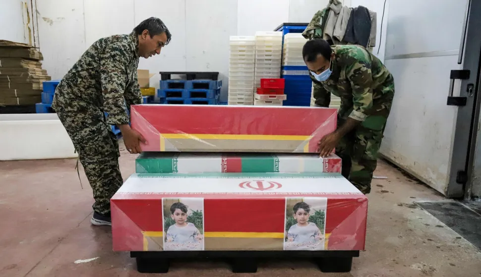 (FILES) In this picture obtained from Iran's ISNA news agency, mourners prepare the coffins of children who were killed in a reported strike on a primary school in Iran?s Hormozgan province for a funeral in Minab on March 3, 2026. The United Nations rights chief called on March 6, 2026, for answers after a deadly strike on an Iranian elementary school, as a media investigation concluded the United States was most likely responsible. On the first day of the war last February 28, 2026, a strike hit an elementary school in the southern Iranian town of Minab and killed at least 150 people, say Iranian officials. (Photo by AMIRHOSSEIN KHORGOOEI/ISNA/AFP)