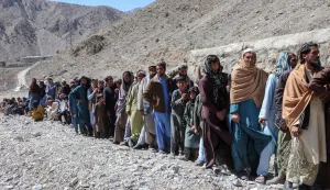 Afghan men queue to receive packages of fortified biscuits distributed by the United Nations World Food Programme (WFP) organisation in the Laja Mangal district of Paktia province on March 16, 2026. The World Food Programme (WFP) said on March 15 that it has started delivering "life-saving food" to over 20,000 Afghan families displaced by the conflict with Pakistan, warning "further instability will push millions into hunger". (Photo by AFP)