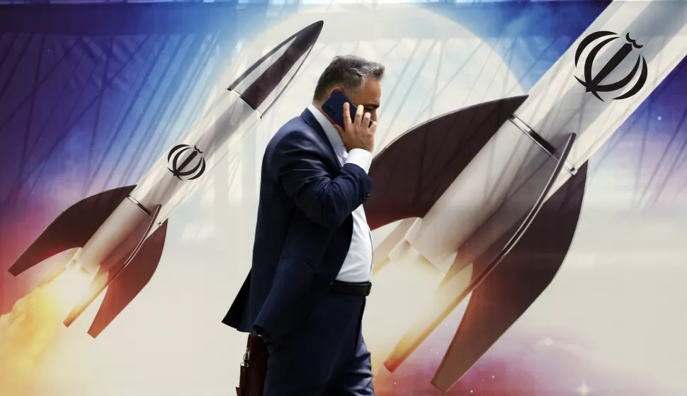 epa11281649 An Iranian man walks past an anti-Israel banner carrying pictures of Iranian missiles, in Tehran, Iran, 16 April 2024. Iranian President Ebrahim Raisi on 14 April said any new targeting of his country will be met with stronger response, after Iran's Islamic Revolutionary Guards Corps (IRGC) launched drones and rockets towards Israel late on 13 April. The Israeli Chief of the General Staff LTG Herzi Halevi said on 15 April the Iranian launch of missiles and drones against Israel will be met with a response. EPA/ABEDIN TAHERKENAREH