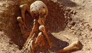 This photograph taken on March 17, 2026 shows an archeological dig site revealing gallic (Gaulois) burial sites in central Dijon, central-eastern France. In the very heart of Dijon, five new tombs of Gauls buried in a seated position have been discovered during preventive excavations ? rare types of burials that raise many questions. For the past few days, pupils at the Josephine Baker primary school group in Dijon have had a new attraction: a particularly well-preserved skeleton lying at the bottom of a circular pit, in an excavation area right next to their playground. (Photo by Fr?d?ric BOURIGAULT/AFP)