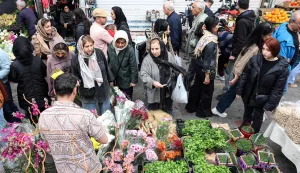 Iranians shop for flowers at the Tajrish Bazaar in northern Tehran on March 19, 2026, on the eve of Nowruz (Noruz), the Persian New Year. The United States and Israel began the war on February 28, 2026, by attacking Iran and killing its supreme leader. Iran retaliated with strikes against Israel and US allies and interests across the Gulf and Iraq, drawing the whole region into war. (Photo by AFP)/