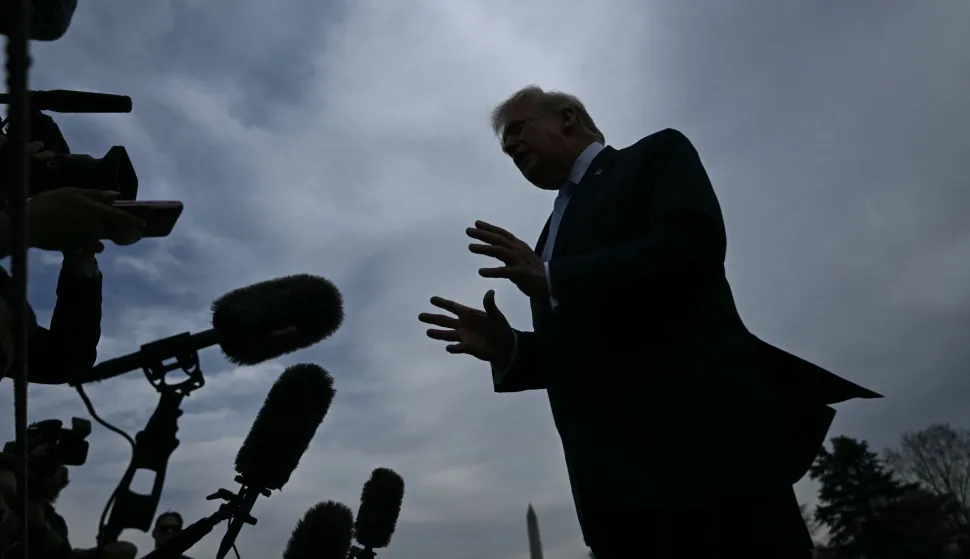 US President Donald Trump speaks to journalists before boarding Marine One as he departs from the South Lawn of the White House in Washington, DC, on March 20, 2026 for his Mar-a-Lago residence, where he will spend the weekend. (Photo by Brendan SMIALOWSKI/AFP)