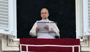 Pope Leo XIV addresses the crowd from the window of the apostolic palace overlooking St. Peter's square during the Angelus prayer in The Vatican on March 22, 2026. (Photo by Alberto PIZZOLI/AFP)