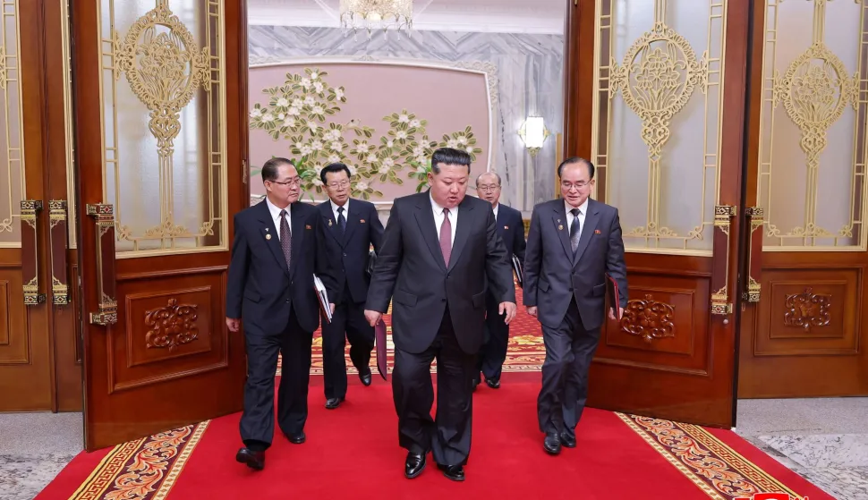 This picture taken on March 22, 2026 and released by North Korea's official Korean Central News Agency (KCNA) on March 23, 2026 shows North Korean leader Kim Jong Un (C) at the First Session of the 15th Supreme People's Assembly at Mansudae Assembly Hall in Pyongyang. North Korea's rubber-stamp legislature has re-elected Kim Jong Un as president of state affairs, state media reported on March 23. (Photo by KCNA VIA KNS/AFP)/South Korea OUT/---EDITORS NOTE--- RESTRICTED TO EDITORIAL USE - MANDATORY CREDIT "AFP PHOTO/KCNA VIA KNS" - NO MARKETING NO ADVERTISING CAMPAIGNS - DISTRIBUTED AS A SERVICE TO CLIENTSTHIS PICTURE WAS MADE AVAILABLE BY A THIRD PARTY. AFP CAN NOT INDEPENDENTLY VERIFY THE AUTHENTICITY, LOCATION, DATE AND CONTENT OF THIS IMAGE./
