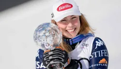 USA's Mikaela Shiffrin poses with her crystal globe trophy for overall Slalom World Cup leader after the women's FIS Ski World Cup slalom race, in which she placed first, too, in Kvitfjell, near Lillehammer, Norway on March 24, 2026. (Photo by Cornelius Poppe/NTB/AFP)/Norway OUT