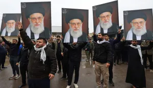 People hold portraits of the slain Iranian supreme leader Ayatollah Ali Khamenei while taking part during the funeral of the Hashd al-Shaabi operations commander for Al-Anbar, Saad Dawai in Baghdad on March 24, 2026. Fifteen fighters from the Hashd al-Shaabi were killed before dawn on March 24 in an ?American? strike on Al-Anbar province in western Iraq, according to an updated death toll published by this alliance of former paramilitaries, which includes pro-Iranian groups. Among the victims is ?the Hashd al-Shaabi operations commander for Al-Anbar, Saad Dawa?,? the alliance said in a statement. Iraq has been drawn into the Middle East war triggered by the US-Israel attack on its neighbour Iran on February 28. (Photo by AHMAD AL-RUBAYE/AFP)