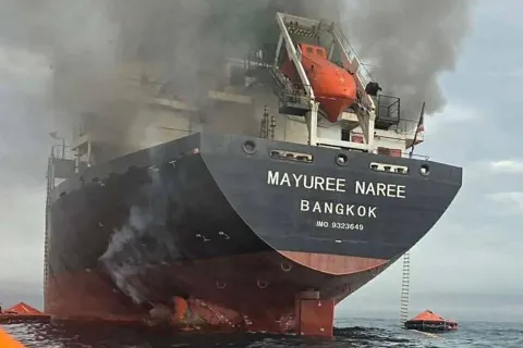 TOPSHOT - This handout photo taken on March 11, 2026 and released by the Royal Thai Navy shows smoke rising from the Thai bulk carrier 'Mayuree Naree' near the Strait of Hormuz after an attack. A Thai bulk carrier travelling in the crucial Strait of Hormuz was attacked March 11, with 20 crew members rescued so far, the Thai navy said. (Photo by Handout/ROYAL THAI NAVY/AFP)/-----EDITORS NOTE --- RESTRICTED TO EDITORIAL USE - MANDATORY CREDIT "AFP PHOTO/ROYAL THAI NAVY " - NO MARKETING - NO ADVERTISING CAMPAIGNS - DISTRIBUTED AS A SERVICE TO CLIENTS -