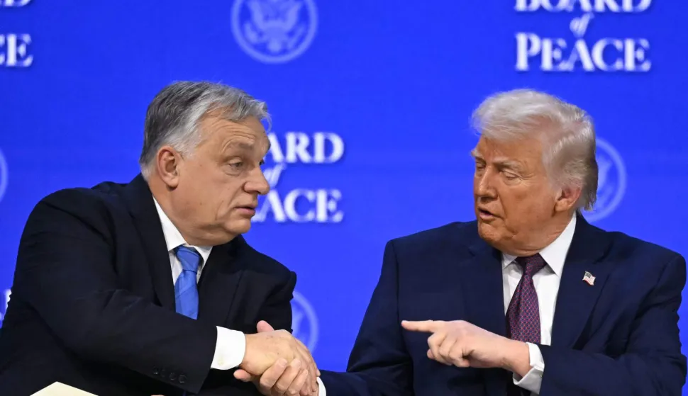 Hungary's Prime Minister Viktor Orban (L) shakes hands with US President Donald Trump (C) at the "Board of Peace" meeting during the World Economic Forum (WEF) annual meeting in Davos on January 22, 2026. US President Donald Trump will show off his new "Board of Peace" at Davos on January 22, 2026 burnishing his claim to be a peacemaker a day after backing off his own threats against Greenland. Originally meant to oversee the rebuilding of Gaza after the war between Hamas and Israel, the board's charter does not limit its role to the Strip, and has sparked concerns that Trump wants it to rival the United Nations. (Photo by Fabrice COFFRINI/AFP)