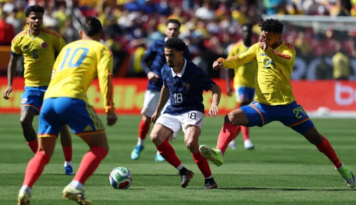 France's midfielder #18 Warren Zaire-Emery (C) controls the ball challenged Colombia's forward #24 Luis Suarez and Colombia's midfielder #10 James Rodriguez during a friendly football match between Colombia and France at Northwest Stadium in Landover, Maryland, on March 29, 2026. (Photo by FRANCK FIFE/AFP)