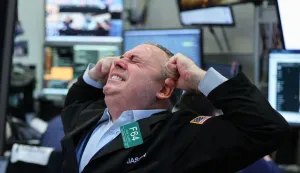 A trader works on the floor of the New York Stock Exchange (NYSE) at the opening bell in New York on March 24, 2026. European and US stocks resumed sliding and oil prices jumped on Tuesday as traders turned cautious over the prospect of a negotiated agreement between the United States and Iran to end the Middle East war. (Photo by ANGELA WEISS/AFP)