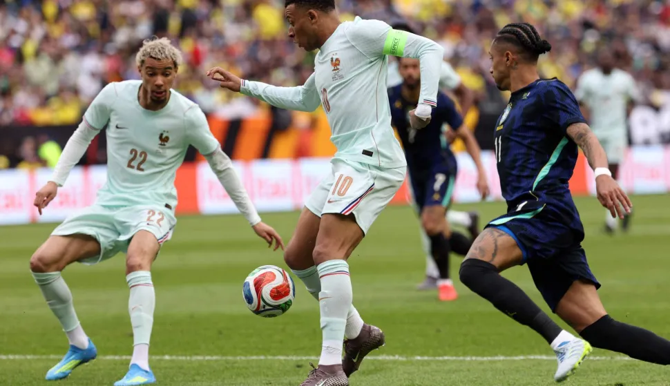 France's forward #10 Kylian Mbappe controls the ball between France forward #22 Hugo Ekitike and Brazil's midfielder #11 Raphinha during a friendly football match between Brazil and France at Gillette Stadium in Foxborough, Massachusetts, on March 26, 2026. (Photo by FRANCK FIFE/AFP)