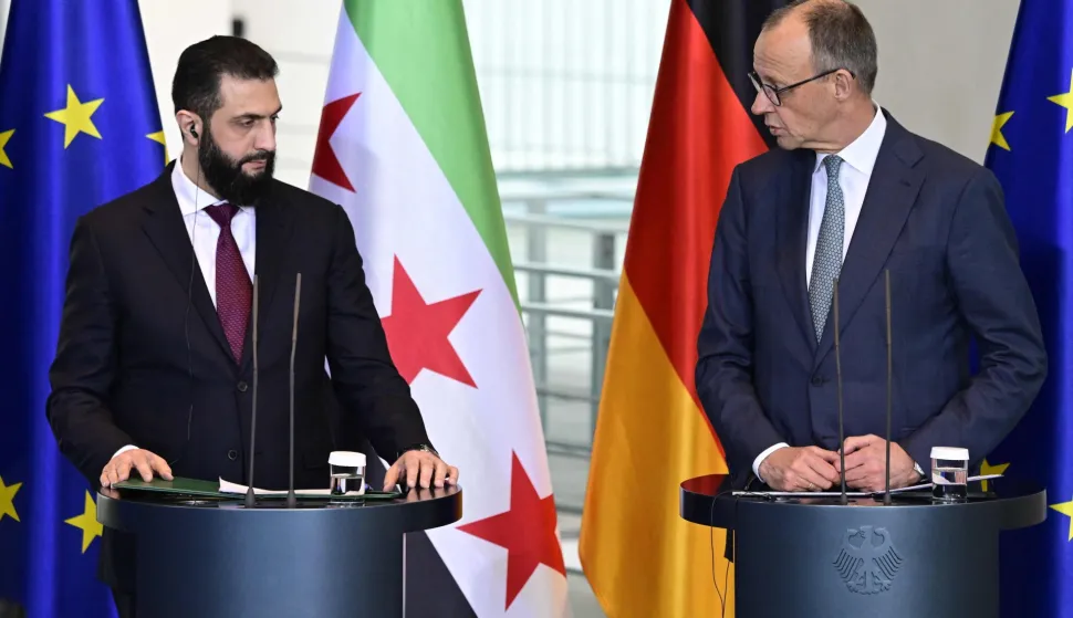 German Chancellor Friedrich Merz (R) and Syrian President Ahmed al-Sharaa address a joint press conference after talks at the Chancellery in Berlin on March 30, 2026. Syria's President Ahmed al-Sharaa visits Germany on Monday for talks on the Middle East war, rebuilding his country and Berlin's efforts to send back Syrian refugees. (Photo by John MACDOUGALL/AFP)