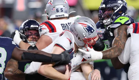 SANTA CLARA, CALIFORNIA - FEBRUARY 08: Drake Maye #10 of the New England Patriots is sacked by Byron Murphy II #91 of the Seattle Seahawks and Leonard Williams #99 of the Seattle Seahawks during the fourth quarter in Super Bowl LX at Levi's Stadium on February 08, 2026 in Santa Clara, California. Kevin C. Cox/Getty Images/AFP (Photo by Kevin C. Cox/GETTY IMAGES NORTH AMERICA/Getty Images via AFP)