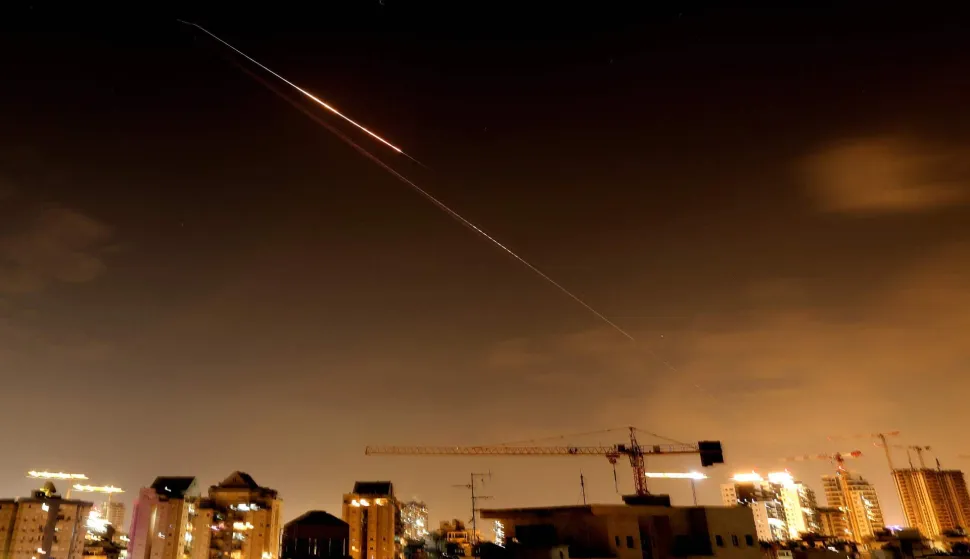 Rocket trails are seen in the sky above the Israeli coastal city of Netanya amid a fresh barrage of Iranian missile attacks late on March 27, 2026. Emergency responders said a man was killed in Israel on March 28 after the Israeli military reported missiles fired from Iran. (Photo by JACK GUEZ/AFP)/