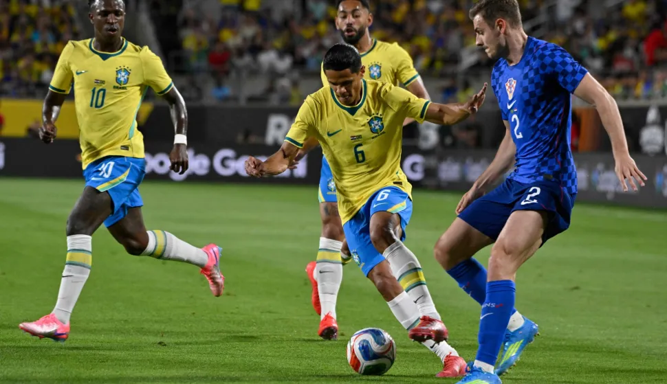 Brazil's defender #06 Douglas Santos moves the ball past Croatia's defender #02 Josip Stanisic during a friendly football match between Brazil and Croatia at Camping World Stadium in Orlando, Florida, on March 31, 2026. (Photo by MIGUEL J RODRIGUEZ CARRILLO/AFP)