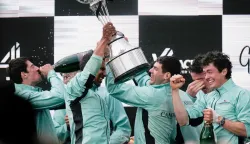 Cambridge's French president, Noam Mouelle celebrates lifts the trophy after winning the 171th men's boat race between Oxford University and Cambridge University on the River Thames in London on April 4, 2026. (Photo by CARLOS JASSO/AFP)