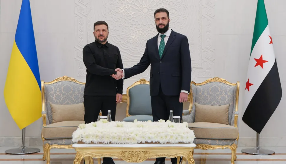 This handout photograph released by the official Syrian Arab News Agency (SANA) shows Ukraine's President Volodymyr Zelensky (L) and Syrian President Ahmed al-Sharaa shaking hands during their meeting in Damascus on April 5, 2026. The visit follows Zelensky's trip to Turkey on April 4 and a Gulf tour the week before against the backdrop of the war in the Middle East, where he sought to clinch security deals and exchange Ukrainian drone expertise for air defence missiles. (Photo by SANA/AFP)/XGTY/RESTRICTED TO EDITORIAL USE - MANDATORY CREDIT "AFP PHOTO/SANA" - HANDOUT - NO MARKETING NO ADVERTISING CAMPAIGNS - DISTRIBUTED AS A SERVICE TO CLIENTS