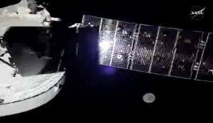 This screengrab taken from a NASA livestream shows the Orion spacecraft with one of its four solar array panels, with the Moon in the distance, on April 5, 2026. The four astronauts for the Artemis II mission were gearing up April 4 for their long-anticipated lunar flyby, including reviewing the surface features they must analyze and photograph during their time circling the Moon. (Photo by NASA/AFP)/RESTRICTED TO EDITORIAL USE - MANDATORY CREDIT "AFP PHOTO/NASA livestream" - HANDOUT - NO MARKETING NO ADVERTISING CAMPAIGNS - DISTRIBUTED AS A SERVICE TO CLIENTS