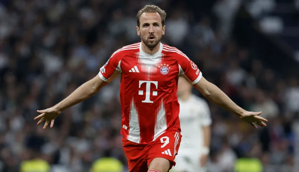 Bayern Munich's English forward #09 Harry Kane celebrates scoring his team's second goal during the UEFA Champions League quarter final first leg football match between Real Madrid CF and FC Bayern Munich at Santiago Bernabeu Stadium in Madrid on April 7, 2026. (Photo by Oscar DEL POZO/AFP)