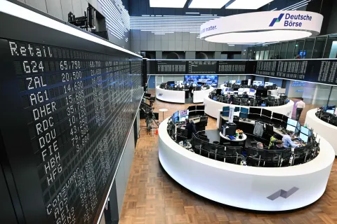 Traders work in front of a board displaying Germany's share index DAX on April 8, 2026 in Frankfurt am Main, western Germany. Oil prices plunged while stocks soared after the announcement of a two-week ceasefire announced barely an hour before US President Donald Trump's deadline to obliterate Iran, which has agreed to temporarily reopen the Strait of Hormuz. (Photo by Kirill KUDRYAVTSEV/AFP)