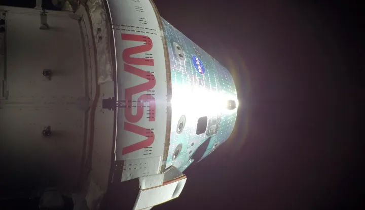 This handout picture released on April 8, 2026 by NASA, shows the Orion spacecraft on the sixth day into the Artemis II mission, photographed from one of the cameras mounted on its solar array wings, on April 7, 2026. During their historic lunar flyby, astronauts on NASA's Artemis II mission witnessed meteorites striking the rugged surface of the Moon, a sight that has piqued scientists' curiosity. "That was definitely impact flashes on the moon. And Jeremy (Hansen) just saw another one," mission commander Reid Wiseman reported on April 6, 2026 while flying around the Moon, the first such journey by humans in more than half a century. (Photo by Handout/NASA/AFP)/RESTRICTED TO EDITORIAL USE - MANDATORY CREDIT "AFP PHOTO/NASA" - HANDOUT - NO MARKETING NO ADVERTISING CAMPAIGNS - DISTRIBUTED AS A SERVICE TO CLIENTS