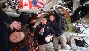 This screengrab from a NASA live broadcast video shows (L-R) NASA astronaut and Artemis II Mission Specialist Christina Koch, NASA astronaut and Artemis II pilot Victor Glover, Canadian Space Agency astronaut Artemis II Mission Specialist Jeremy Hansen and NASA astronaut and Artemis II Commander Reid Wiseman during a press call as they travel to the Moon in the Orion spacecraft, on April 3, 2026. The four Artemis astronauts have passed the halfway point between Earth and the Moon on the way to their planned lunar flyby, NASA said on Friday evening. "You are now closer to the moon than you are to us on Earth," mission control told the astronauts at around 11 pm (0400 GMT), according to the space agency's official live broadcast. (Photo by NASA/AFP)/RESTRICTED TO EDITORIAL USE - MANDATORY CREDIT "AFP PHOTO/NASA" - NO MARKETING NO ADVERTISING CAMPAIGNS - DISTRIBUTED AS A SERVICE TO CLIENTS