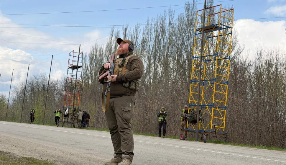 Ukrainian servicemen cover the road with a net to protect vehicles from drone attacks at an undisclosed location in the Zaporizhzhia region on April 10, 2026, amid the Russian invasion of Ukraine. (Photo by Darya NAZAROVA/AFP)