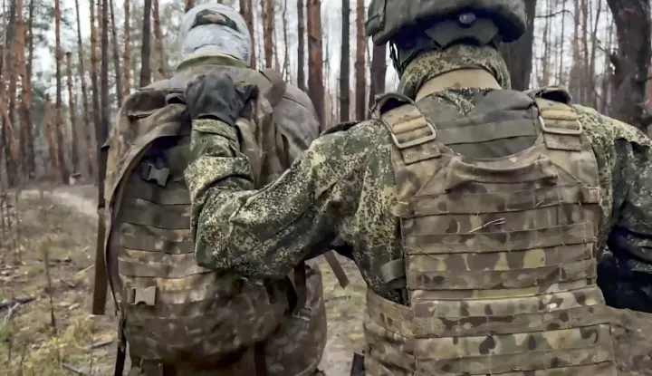 epa12571635 A still image taken from a handout video provided by the Russian Defence Ministry press service on 05 December 2025 shows a Russian serviceman escorting a captured Ukrainian serviceman in an undisclosed location in Ukraine. EPA/RUSSIAN DEFENCE MINISTRY PRESS SERVICE/HANDOUT BEST QUALITY AVAILABLEHANDOUT EDITORIAL USE ONLY/NO SALES