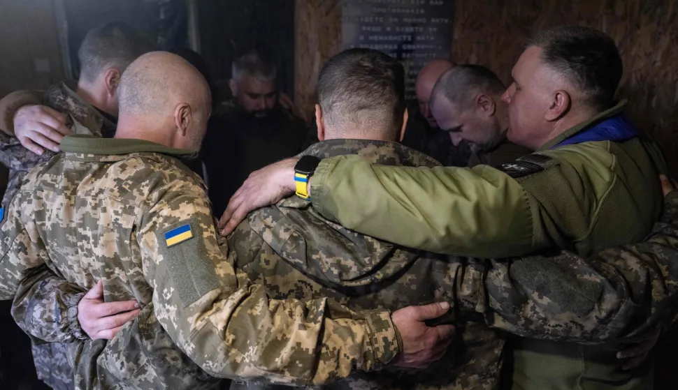 In this handout photograph taken on April 10, 2026 and released on April 11, 2026 by the press service of the 93rd Kholodnyi Yar Separate Mechanized Brigade of the Ukrainian Ground Forces, Ukrainian servicemen pray during a religious service in a room turned into a church at an undisclosed location near Sloviansk, Donetsk region, amid the Russian invasion of Ukraine. Russia and Ukraine fired waves of drones at each other between late April 10, 2026 and early April 11, 2026, just hours before a temporary ceasefire between the two was set to take effect for Orthodox Easter, according to officials. (Photo by Iryna Rybakova/The 93rd Kholodnyi Yar Separate Mechanized Brigade/AFP)/RESTRICTED TO EDITORIAL USE - MANDATORY CREDIT "AFP PHOTO/IRYNA RYBAKOVA/PRESS SERVICE OF THE 93RD KHOLODNYI YAR SEPARATE MECHANIZED BRIGADE" - NO MARKETING NO ADVERTISING CAMPAIGNS - DISTRIBUTED AS A SERVICE TO CLIENTS