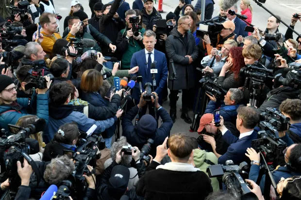 TOPSHOT - Peter Magyar (C), leader of the pro-European conservative TISZA party, talks with journalists outside a polling station in Budapest during a general election in Hungary, on April 12, 2026. The vote could end Hungarian Prime Minister Viktor Orban's 16-year stint in power as the EU's longest serving current leader and a self-decribed "thorn" in the bloc's side. (Photo by Ferenc ISZA/AFP)