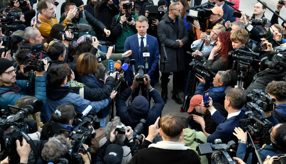 TOPSHOT - Peter Magyar (C), leader of the pro-European conservative TISZA party, talks with journalists outside a polling station in Budapest during a general election in Hungary, on April 12, 2026. The vote could end Hungarian Prime Minister Viktor Orban's 16-year stint in power as the EU's longest serving current leader and a self-decribed "thorn" in the bloc's side. (Photo by Ferenc ISZA/AFP)