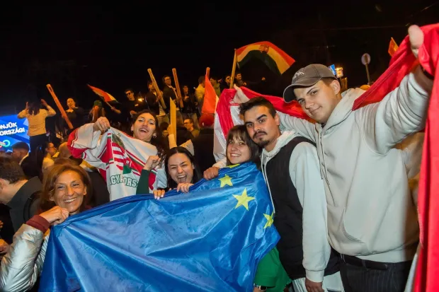 People celebrate in the streets after Hungarian Prime Minister Viktor Orban conceded defeat to Peter Magyar, leader of the pro-European conservative TISZA party, in Budapest, on April 12, 2026. Polls closed in Hungary's parliamentary election, with turnout reaching a record high in the crunch vote that sees nationalist Prime Minister Viktor Orban's 16-year stint in power face an unprecedented challenge from conservative political newcomer Peter Magyar. (Photo by Ferenc ISZA/AFP)