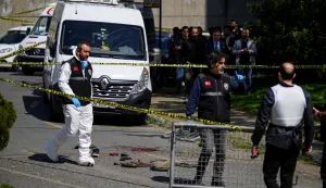 TOPSHOT - Police officials gather outside The Israeli Consulate in Istanbul on April 7, 2026, following a shootout between gunmen and police. One gunman was killed and two others were wounded in a shootout with police outside the Israeli consulate in Istanbul, the local governor said, adding two officers were lightly wounded (Photo by Yasin AKGUL/AFP)