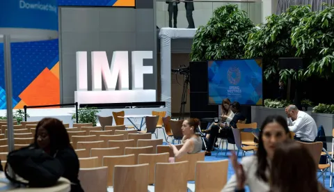 People gather in the atrium of the International Monetary Fund (IMF) building during the first day of the 2026 Spring Meetings of the IMF and the World Bank Group (WBG) in Washington, DC, on April 13, 2026. (Photo by Kent Nishimura/AFP)