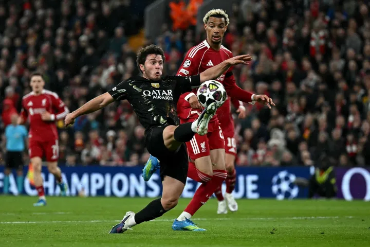 Paris Saint-Germain's Portuguese midfielder #87 Joao Neves controls the ball whilst under pressure from Liverpool's French striker #22 Hugo Ekitike during the UEFA Champions League quarter final, second-leg football match between Liverpool and Paris Saint-Germain at Anfield in Liverpool, north west England on April 14, 2026. (Photo by Paul ELLIS/AFP)