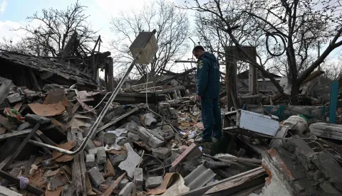 A Russian rescuer stands among the rubble of a destroyed house following an air attack in Yasynuvata, Russia-controlled Donetsk region of Ukraine on April 11, 2026, amid the Russian invasion of Ukraine. (Photo by AFP)